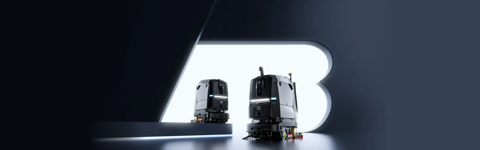 Robots fregadores de gran tamaño PUDU BG1 y BG1 Pro sobre fondo oscuro con la letra B iluminada