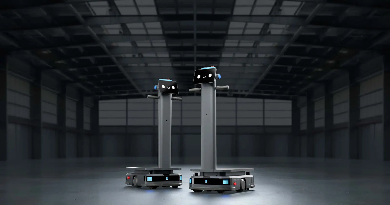 Dos robots de reparto industrial PUDU T300 en una nave industrial oscura